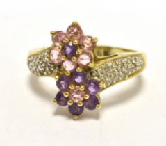 ALMANDINE COCKTAIL RING Wrap over style with two almandine flower heads, diamond accent shoulders on