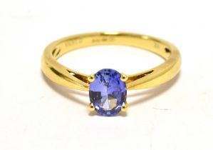 TJC ILIANA 18CT GOLD DRESS RING. The ring set with a single blue (violet) sapphire ring size O - O