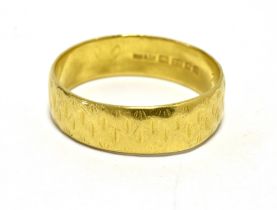 A 22CT GOLD BAND RING The band with textured pattern. Hallmarked London 1964 Ring size P weight 4.5g