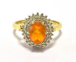 18CT GOLD COCKTAIL RING The ring set with an orange central stone in a bed of diamond accents -
