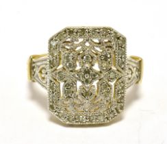 DECO STYLE PLAQUE RING The Plaque and shoulders in pierced fancy pattern, white metal,decorated with
