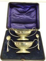 CASED VICTORIAN SILVER SALTS Hallmarked Chester 1899 together with non-matching silver salt spoons.