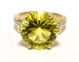 CITRINE COCKTAIL RING The faceted circular citrine in greenish-yellow measuring 12mm in diameter-