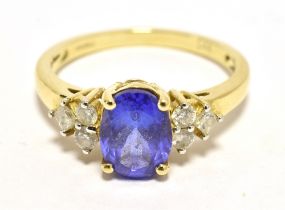 TJC TANZANITE AND DIAMOND COCKTAIL RING The faceted oval Tanzanite measuring aprox 8 x 6 mm