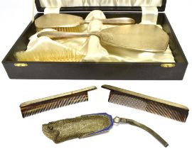 A SILVER DRESSING TABLE SET Comprising a mirror, two brushes together with two silver framed combs