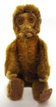 A SCHUCO MONKEY NOVELTY SCENT BOTTLE the jointed brown mohair body with a removable head and
