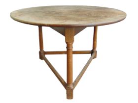 A LATE 19TH OR EARLY 20TH CENTURY OAK CRICKET TABLE the legs joined by stretchers, 73.5cm high,