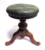 A VICTORIAN MAHOGANY ADJUSTABLE PIANO STOOL with a buttoned green leather top, 46cm high (minimum).