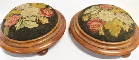 A PAIR OF VICTORIAN MAHOGANY CIRCULAR FOOTSTOOLS with floral wool tapestry tops, on shallow bun