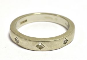 TJC RHAPSODY PLATINUM Diamond accent band ring. Set with three tiny diamonds. Ring size O, Weight