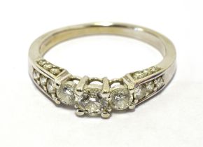 TJC DIAMOND NINE STONE DRESS RING The ring set with nine graduated round cut brilliant diamonds, the
