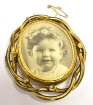 A LATE 19TH/EARLY 20TH CENTURY REVERSE PHOTOGRAPH BROOCH gilt mounted and measuring 6.2 x 5.3cm