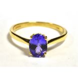 ILIANA 18K GEM SET COCKTAIL RING The ringset with a faceted oval purple garnet measuring 9 x 5mm,