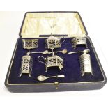 CASED SILVER FOOTED CRUET SET the six cruets of hexagonal shape with pierced bodies on three