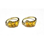 A PAIR OF 9CT GOLD ORANGE GARNET TRIPLE STONE DRESS RINGS Both rings with matched designs