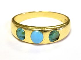 18CT GOLD TURQUOISE SET THREE STONE DRESS RING. The Tapered band set with three turquiose stones,