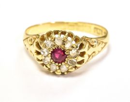 EARLY 20TH CENTURY, 18CT GOLD, OLD CUT DIAMOND AND RUBY CLUSTER RING. The cluster centrally set with