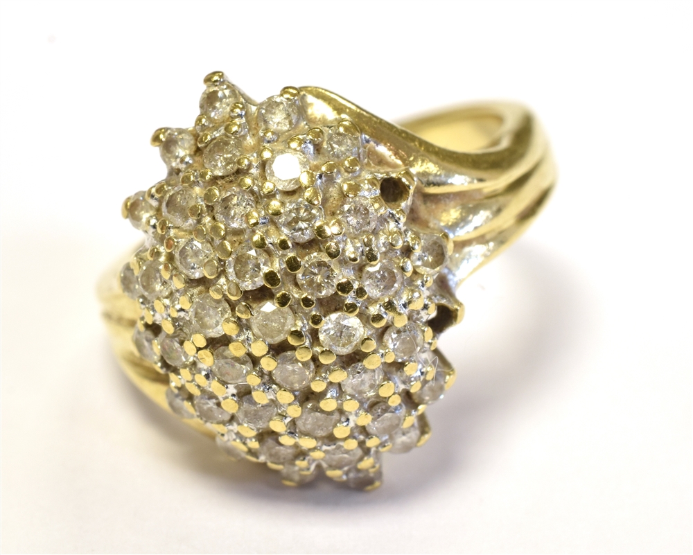 9CT GOLD DIAMOND CLUSTER RING The domed cluster set with numerous tiny diamonds in white metal on