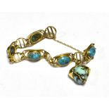 TURQUOISE MATRIX SET OPEN WORK BRACELET The bracelet in unmarked yellow metal, working push clasp,