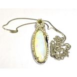 AN OPAL AND DIAMOND PENDANT AND CHAIN The oval opal mounted in diamond set white metal marked 14k