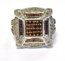 TGGC 417 10K DIAMOND SET STATEMENT RING The head set with diamond accents and orange stone accents