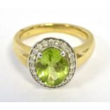 9K PERIDOT AND DIAMOND CLUSTER RING the oval cluster measuring approx 13 x 11mm, ring size O, weight