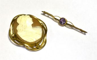 TWO VINTAGE BROOCHES Comprising of an amethyst set safety pin. Brooch in yellow metal stamped 9ct,