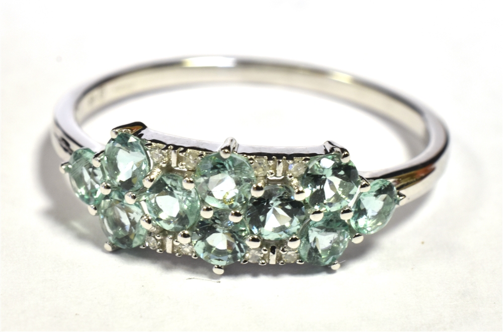 9KT WHITE GOLD AQUAMARINE CLUSTER RING. The ring set with 10 small round cut aquamarines with