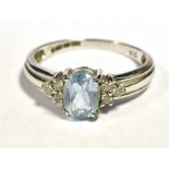 9CT WHITE GOLD SAPPHIRE AND DIAMOND DRESS RING The oval faceted light blue sapphire flanked by three