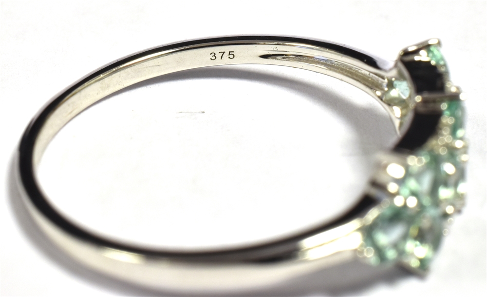 9KT WHITE GOLD AQUAMARINE CLUSTER RING. The ring set with 10 small round cut aquamarines with - Image 2 of 2