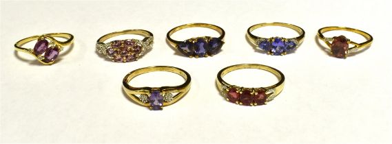 SEVEN DRESS RINGS The rings set in coloured gem, stone and paste. Yellow metal shanks marked 10K