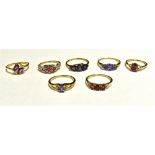 SEVEN DRESS RINGS The rings set in coloured gem, stone and paste. Yellow metal shanks marked 10K