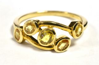 9CT GOLD YELLOW SAPPHIRE RING The ring tension set in open work boat design with five small oval