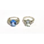 GEM & DIAMOND SET DRESS RINGS To include; oval aquamarine and vivid blue topaz stones flanked by