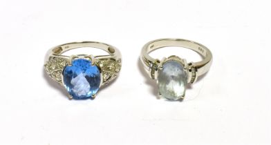 GEM & DIAMOND SET DRESS RINGS To include; oval aquamarine and vivid blue topaz stones flanked by