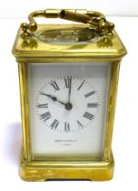 BRASS CARRIAGE CLOCK Retailed by Howell & James Ltd, London, stands 12cm tall, with five bevelled
