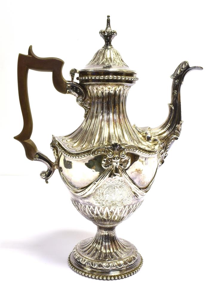GEORGIAN SILVER TEAPOT Stands 31cm tall, with gadrooned pedestal base and neck decorated with