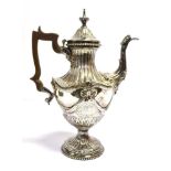 GEORGIAN SILVER TEAPOT Stands 31cm tall, with gadrooned pedestal base and neck decorated with