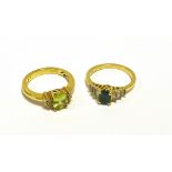 GEM & DIAMOND SET DRESS RINGS Both set in 18ct gold, one oval peridot and one oval emerald,