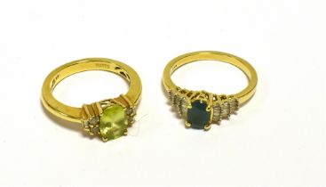 GEM & DIAMOND SET DRESS RINGS Both set in 18ct gold, one oval peridot and one oval emerald,