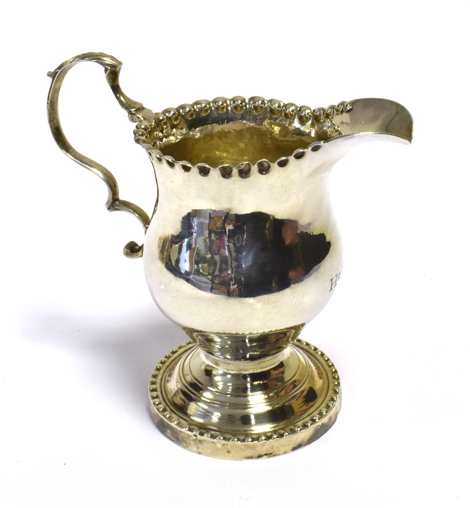 GEORGE III SILVER CREAM JUG With a baluster shaped body on a pedestal foot with pie crust rim. - Image 2 of 2