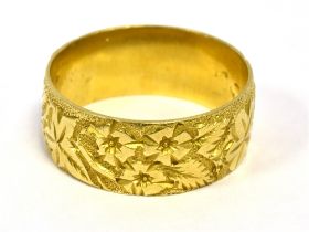 ANTIQUE 18CT GOLD RING 7.2mm wide, entirely decorated with floral and foliate chasing, ring size