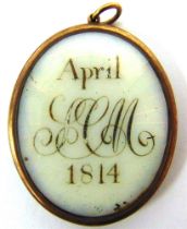 A REGENCY GILT METAL MOURNING LOCKET one side with a monogram and dated 'April 1814', the other side