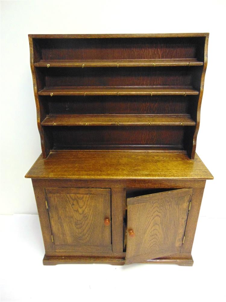 A HAND-MADE MINIATURE OAK DRESSER circa 1954, comprising a rack of three shelves, with an enclosed - Image 2 of 2