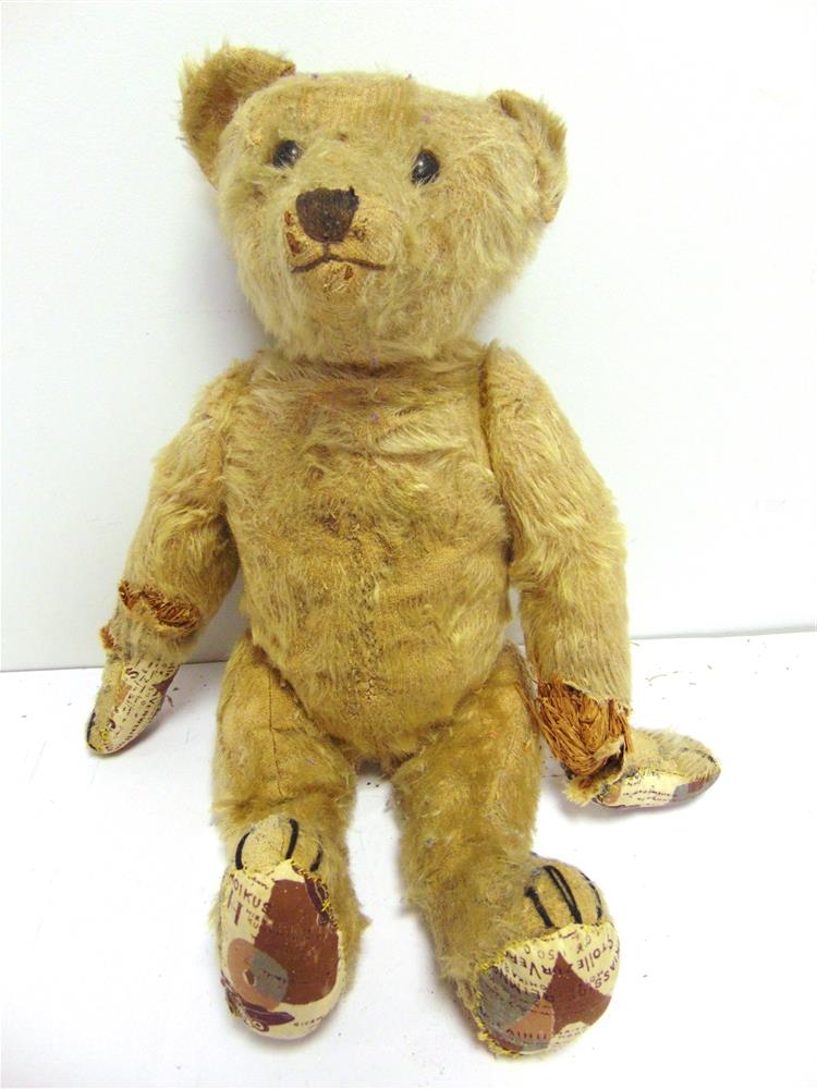 A BLONDE MOHAIR TEDDY BEAR circa 1920, possibly by Steiff, with boot button eyes and a black