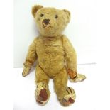 A BLONDE MOHAIR TEDDY BEAR circa 1920, possibly by Steiff, with boot button eyes and a black