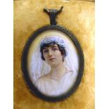A PORTRAIT MINIATURE OF A YOUNG BRIDE circa 1910, watercolour, unsigned, 5cm x 4cm (oval), framed