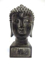 A BRONZED BUDDHA HEAD on a plinth base with cast seal marks to the sides and underside, overall 18.