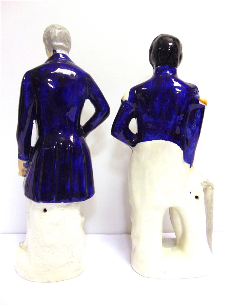 TWO STAFFORDSHIRE PORTRAIT FIGURES comprising 'Wellington', standing in a blue frock coat, with a - Image 2 of 2