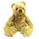 A HERMANN ZOTTY BLONDE MOHAIR TEDDY BEAR with dark orange glass eyes, a brown vertically stitched